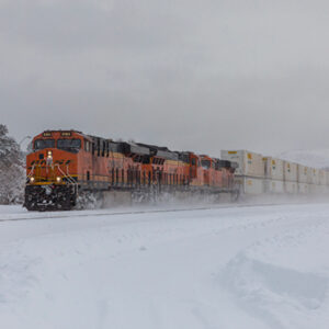 Severe cold weather continues disrupting BNSF’s Northern Transcon, affecting train operations and causing significant shipping delays. Emergency measures, including rerouting and train length restrictions, aim to maintain service reliability.