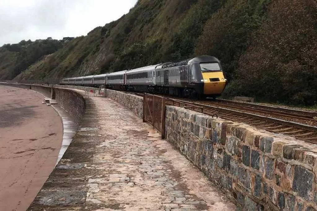 The Devon Railway remains dangerously exposed to severe weather damage, and MPs are calling on the government to fund critical upgrades before another storm severs the southwest rail link. The Devon Railway remains dangerously exposed to severe weather damage, and MPs are calling on the government to fund critical upgrades before another storm severs the southwest rail link.