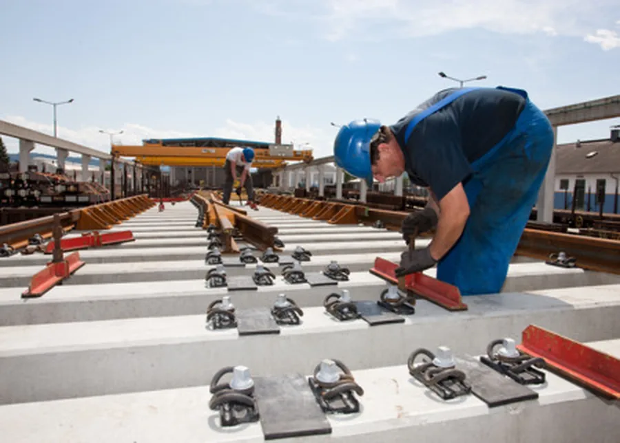 Workers assembling pre-assembled railway turnouts