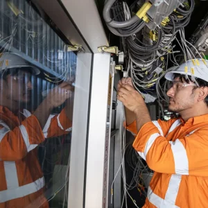 Worker inside a Canberra light rail vehicle during battery upgrade works
