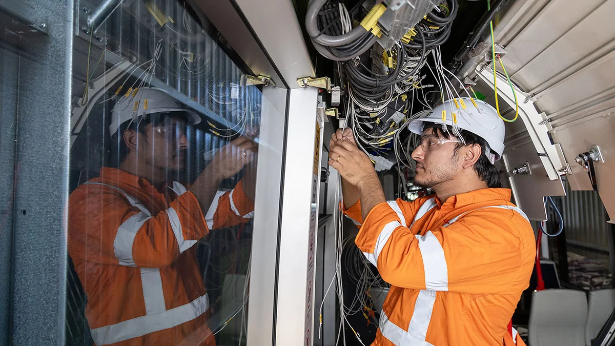 Worker inside a Canberra light rail vehicle during battery upgrade works