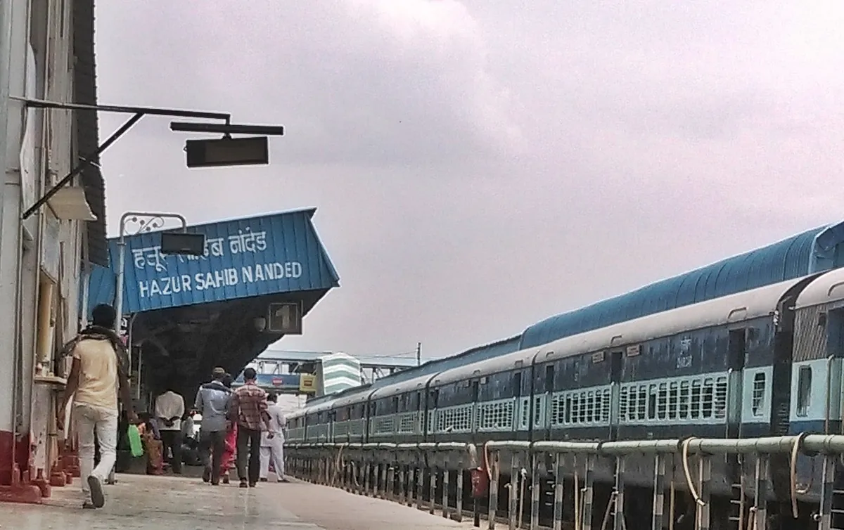 Platform at Hazur Sahib Nanded station with passenger train
