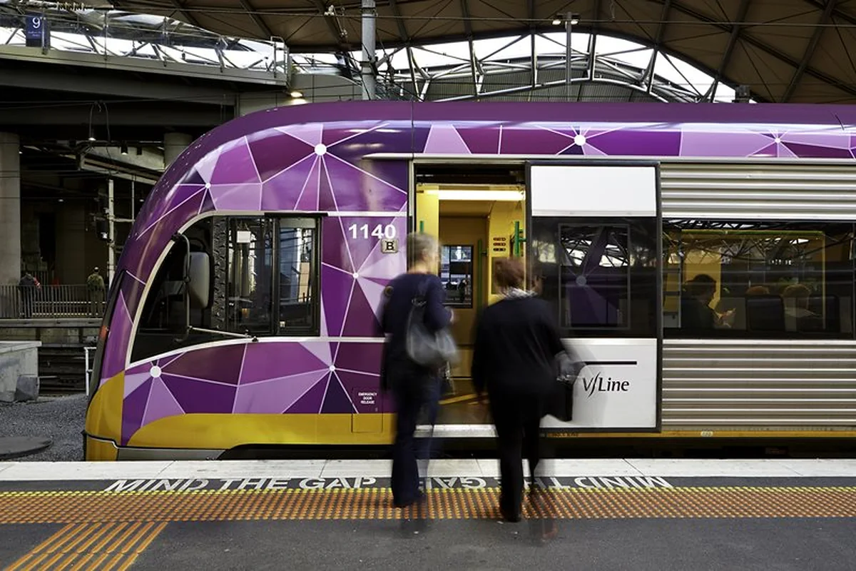 Passengers boarding a V/Line train at a station
