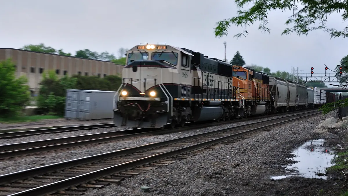 BNSF train under signal bridge BNSF freight train passing under a signal bridge