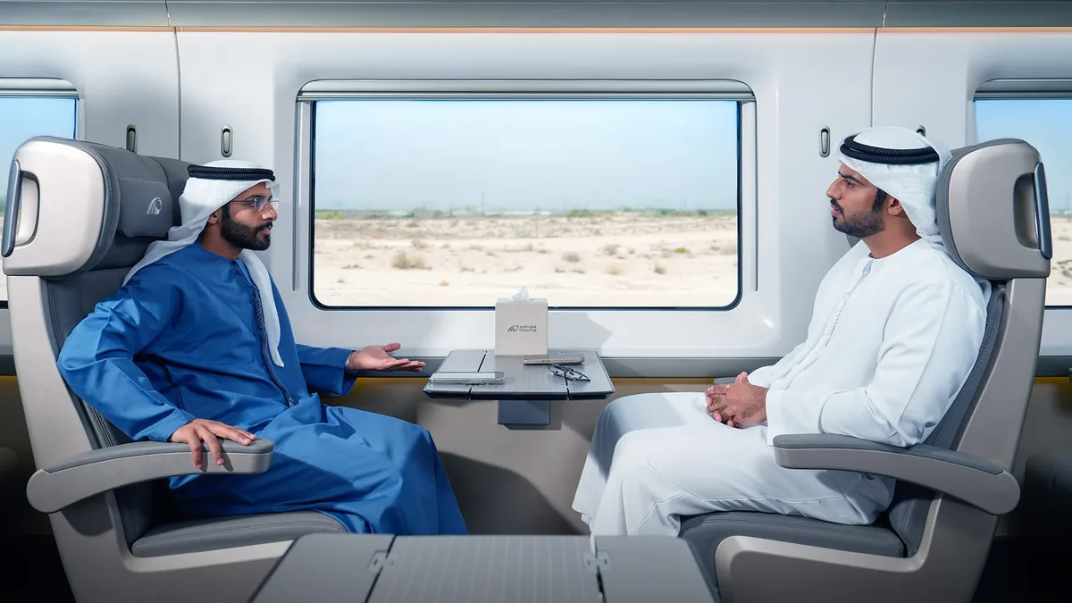 Etihad Rail train interior with passengers Passengers seated inside an Etihad Rail train