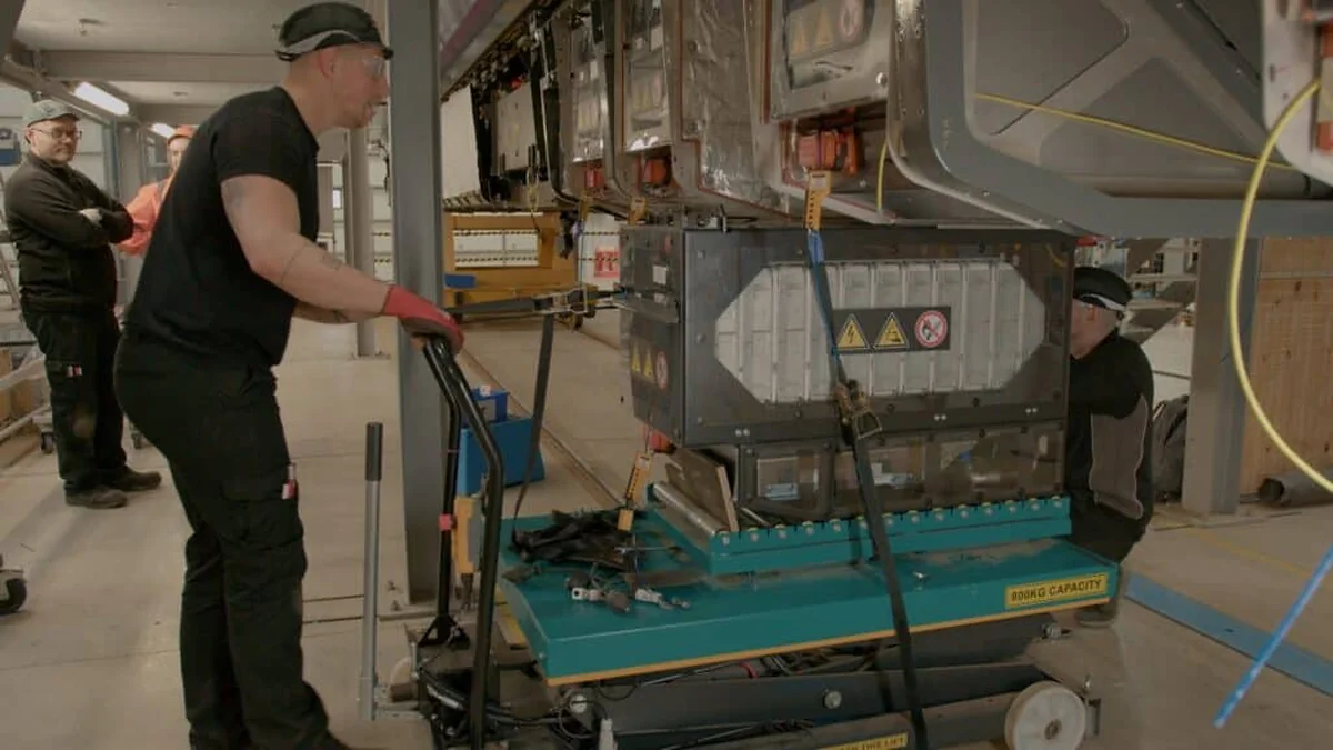 Technicians installing a Turntide battery system on a Hitachi Rail train Technicians installing a Turntide battery system on a Hitachi Rail train
