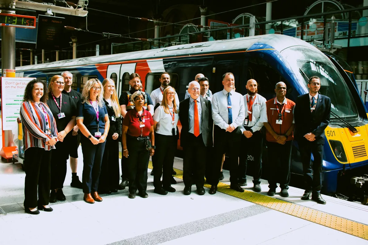 Rail officials and staff beside a newly branded GBR Anglia Class 720 train Rail officials and staff beside a newly branded GBR Anglia Class 720 train