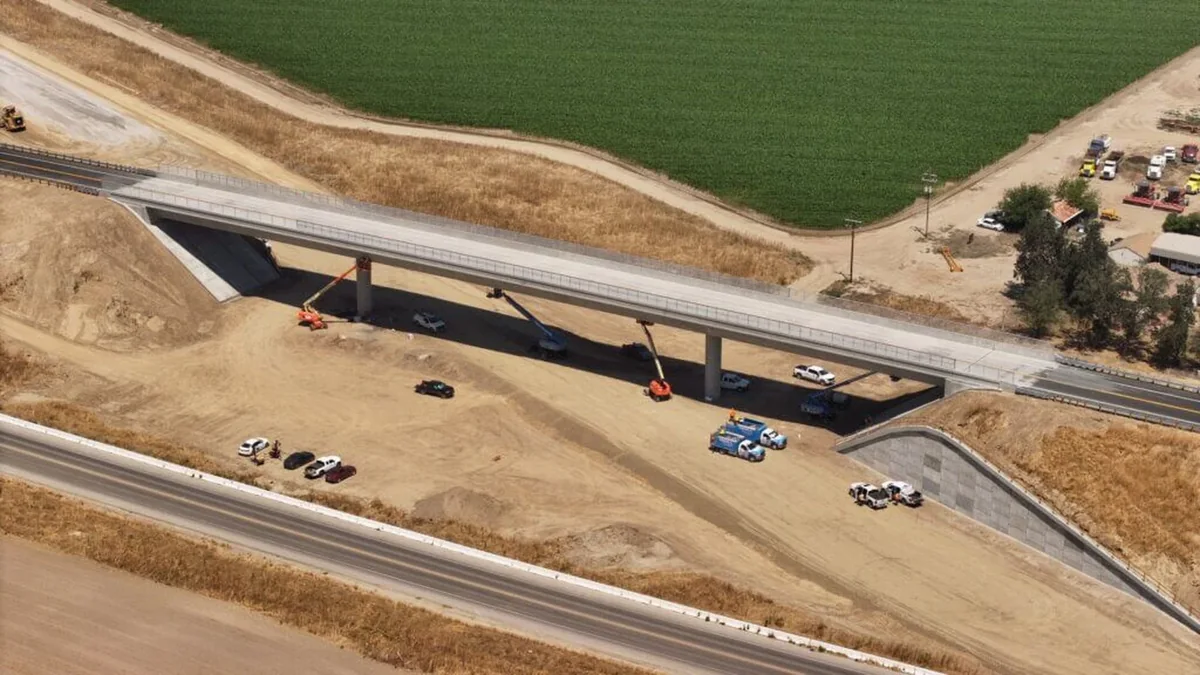 Aerial view of a completed road bridge above the California high-speed rail construction corridor in Kings County Aerial view of a completed road bridge above the California high-speed rail construction corridor in Kings County