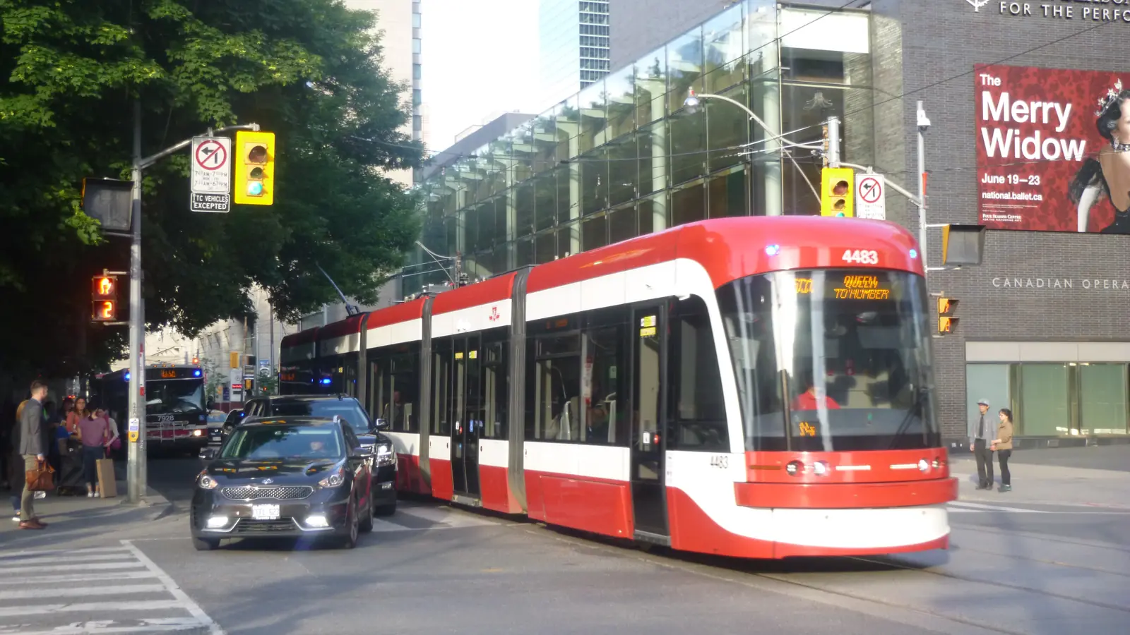 TTC Flexity Outlook streetcar operating beside road traffic on route 501 Queen in Toronto TTC Flexity Outlook streetcar operating beside road traffic on route 501 Queen in Toronto