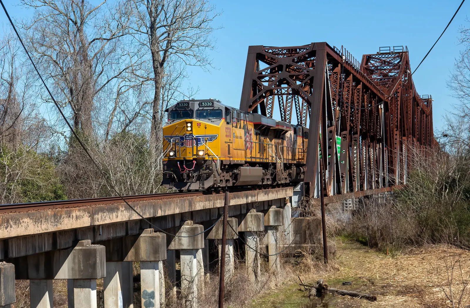 BNSF-led freight train crossing a steel railway bridge in Louisiana BNSF-led freight train crossing a steel railway bridge in Louisiana
