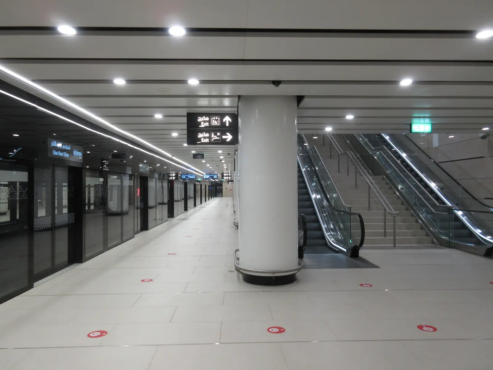 Platform screen doors, signs and escalators at MOE station on the Riyadh Metro Green Line
