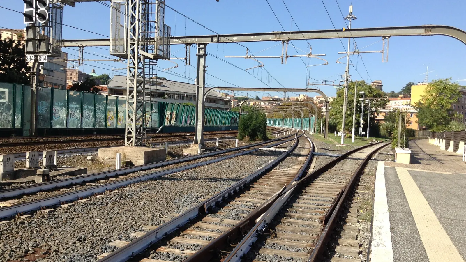 Electrified railway junction and multiple tracks near Roma San Pietro station in Italy