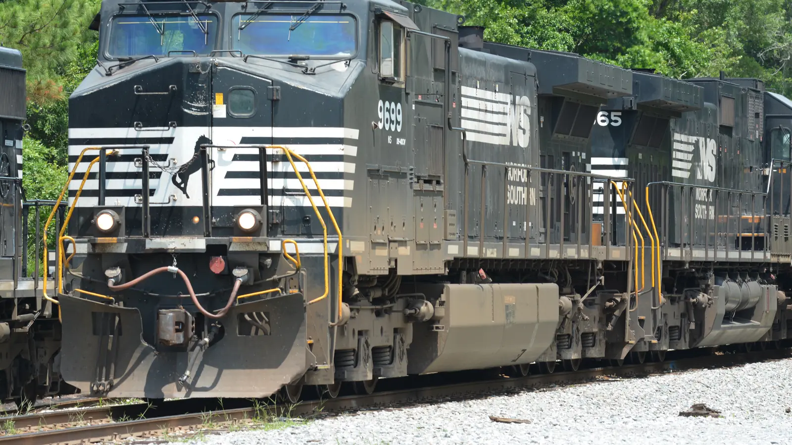 Two black Norfolk Southern diesel locomotives standing on railway tracks. Two black Norfolk Southern diesel locomotives standing on railway tracks.
