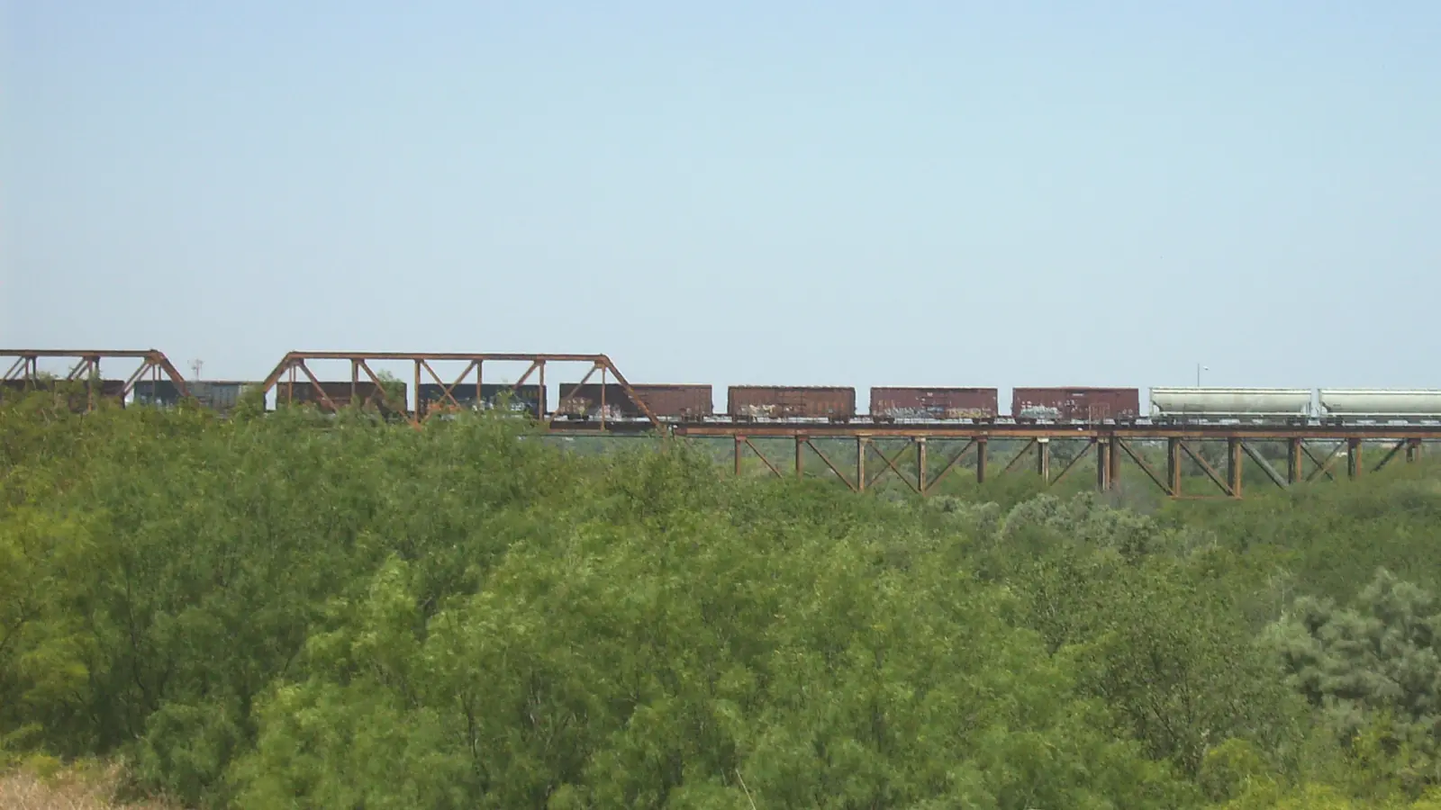 Freight train crossing an international railway bridge near Nuevo Laredo Freight train crossing an international railway bridge near Nuevo Laredo