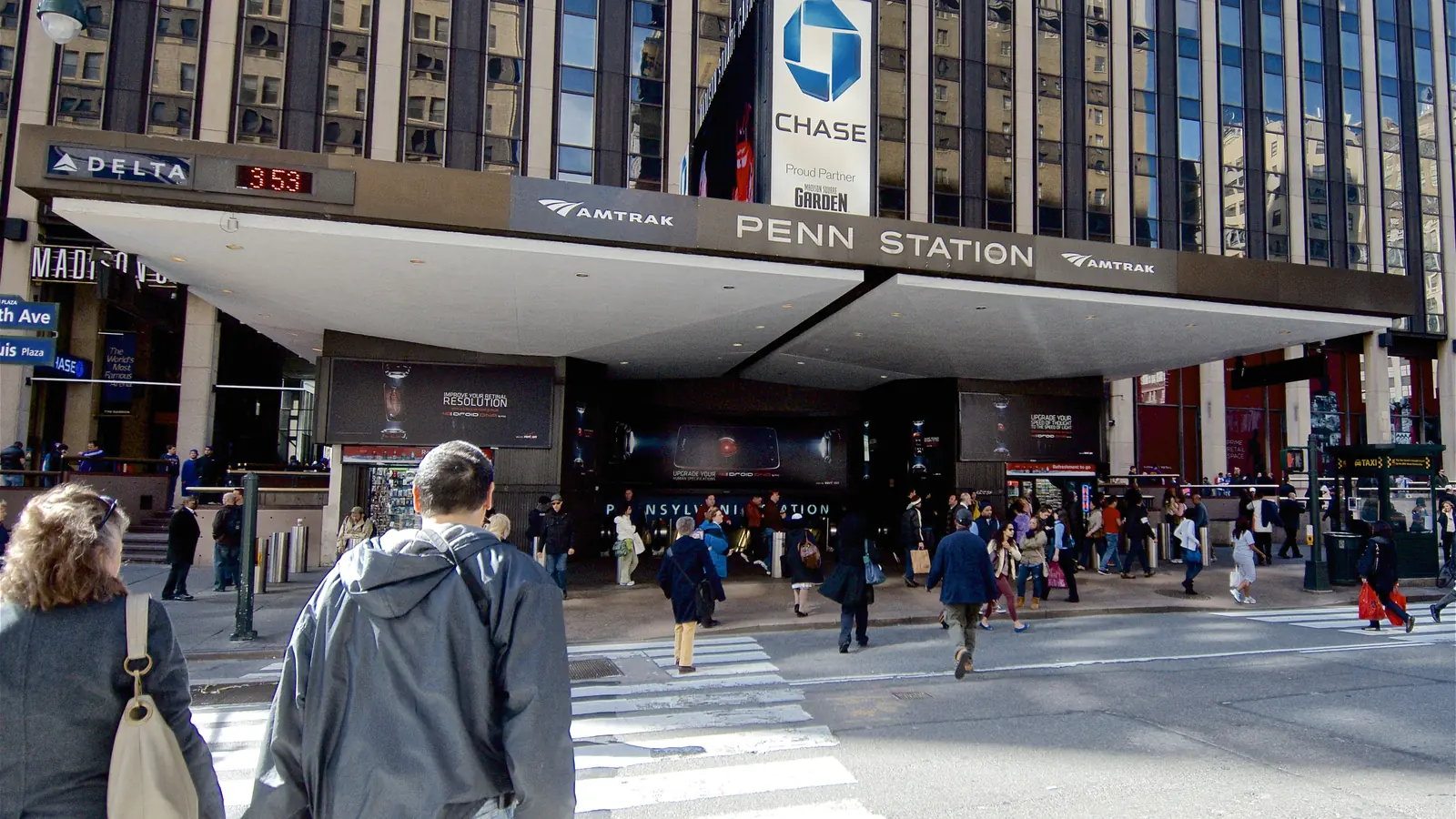 Travelers approach the Seventh Avenue entrance to New York Penn Station.