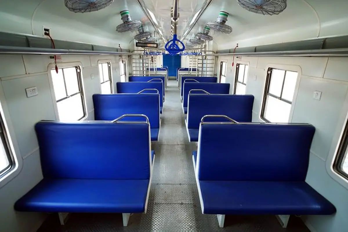 Passenger compartment inside India’s hydrogen train with blue bench seating