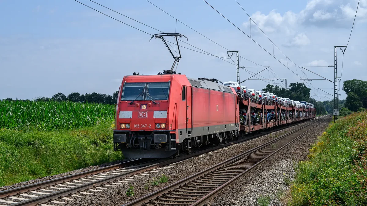 DB Cargo locomotive hauling an automotive freight train on an electrified railway in Germany DB Cargo locomotive hauling an automotive freight train on an electrified railway in Germany