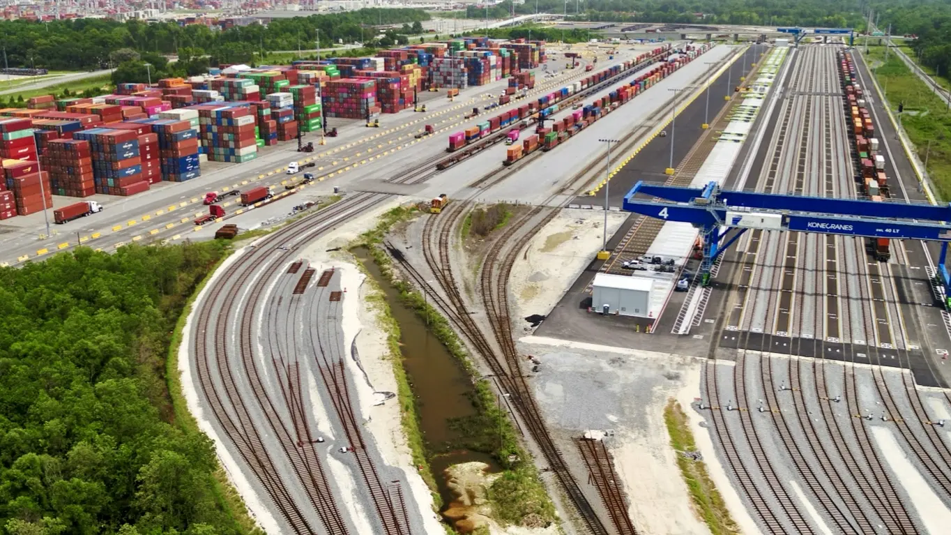 Aerial view of an intermodal rail terminal at the Port of Savannah with tracks, cranes and stacked containers Aerial view of an intermodal rail terminal at the Port of Savannah with tracks, cranes and stacked containers