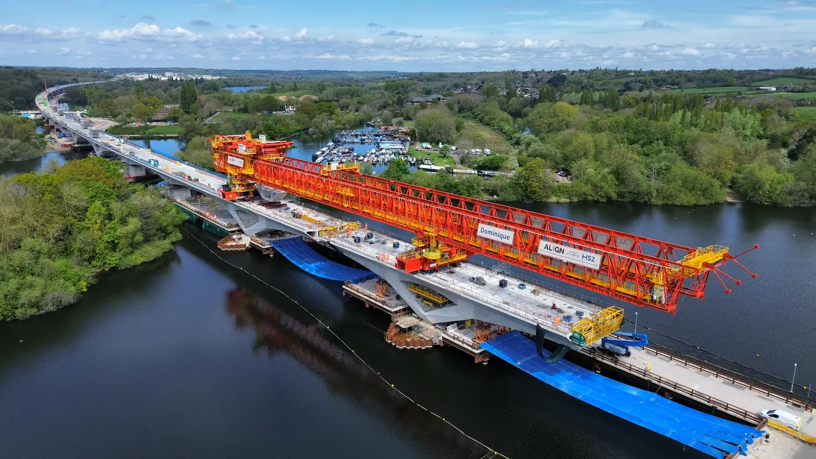 Aerial view of the HS2 Colne Valley Viaduct under construction with Align’s launching girder over a lake. Aerial view of the HS2 Colne Valley Viaduct under construction with Align’s launching girder over a lake.