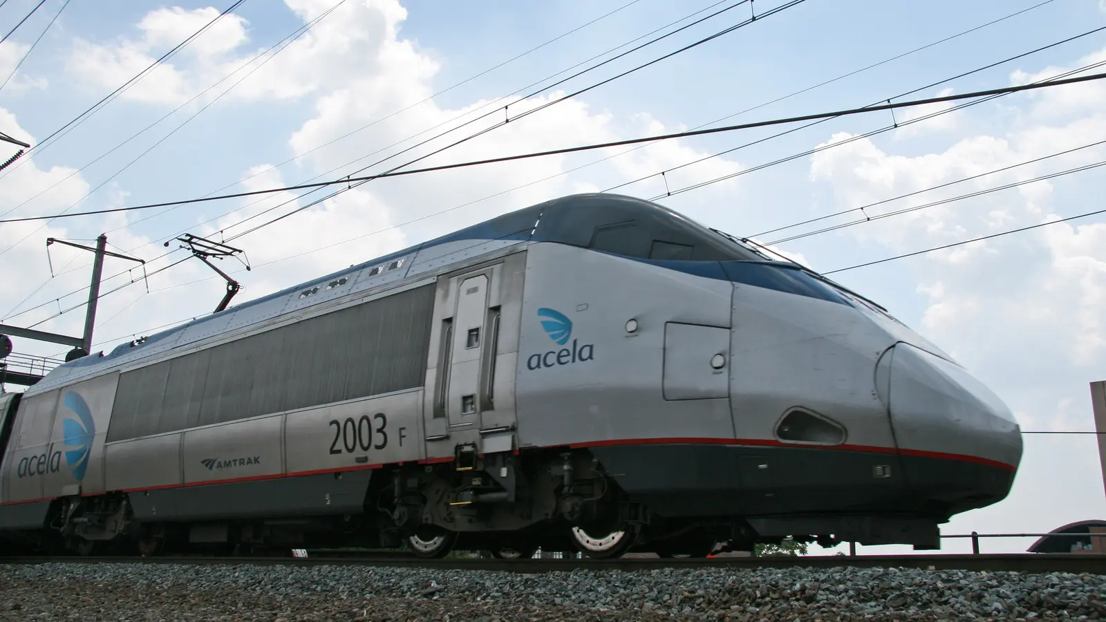 Amtrak Acela locomotive beneath overhead wires in Wilmington, Delaware Amtrak Acela locomotive beneath overhead wires in Wilmington, Delaware