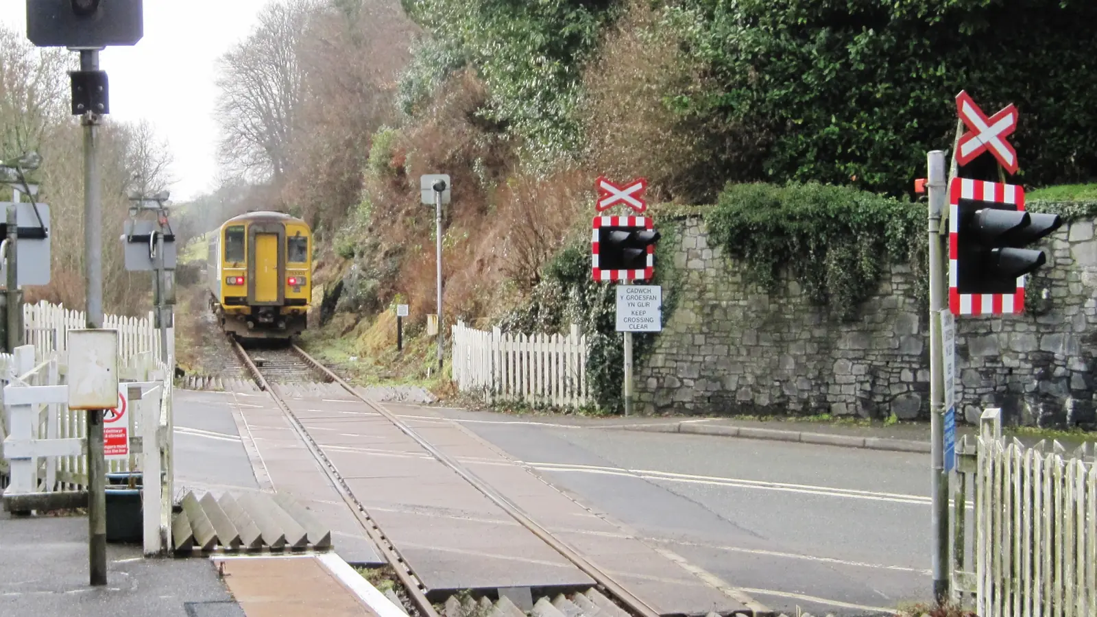 A diesel train leaving a level crossing at Ffairfach on the Heart of Wales line. A diesel train leaving a level crossing at Ffairfach on the Heart of Wales line.