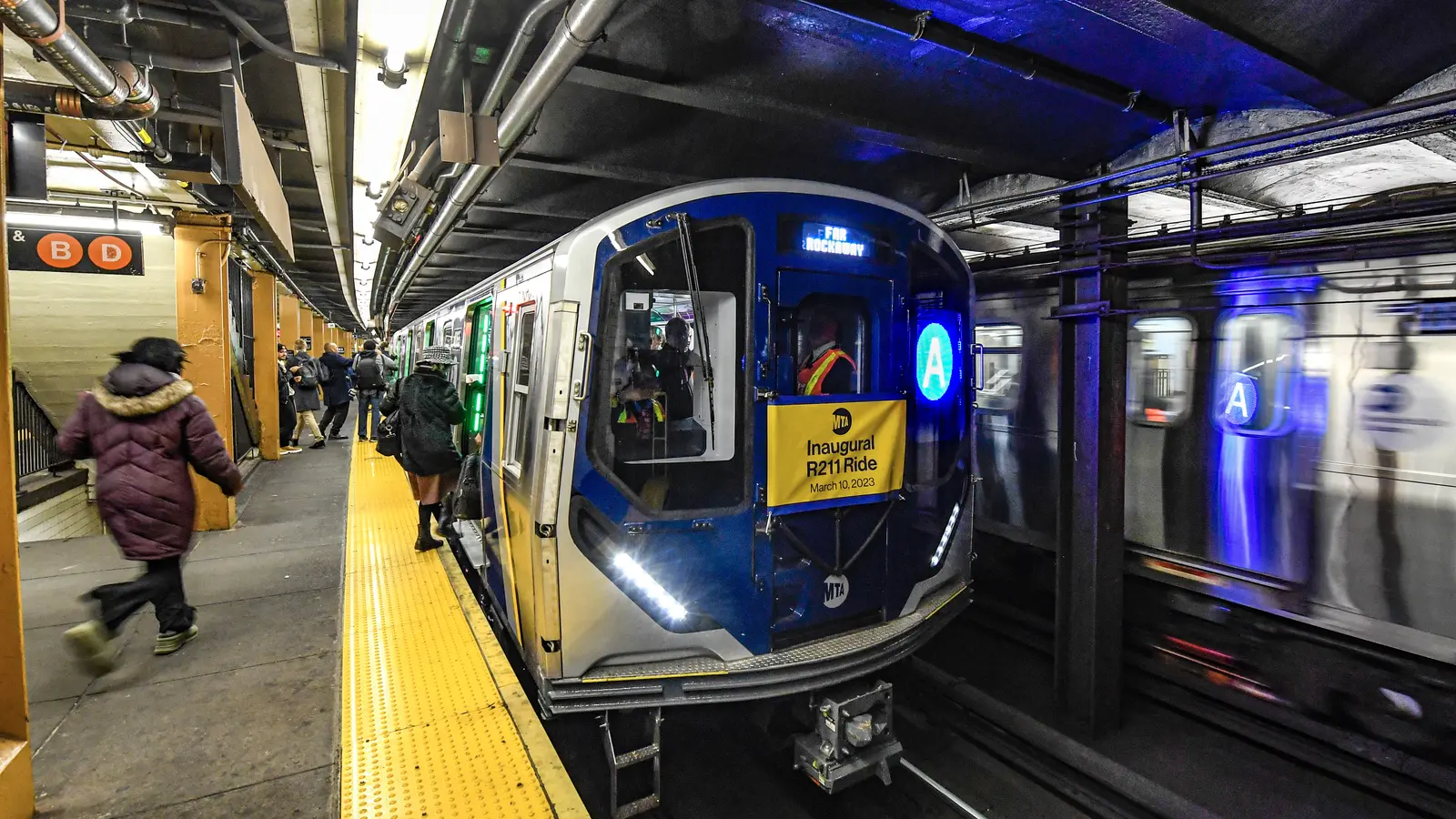 An MTA R211A subway train stopped at 145th Street station beside another train. An MTA R211A subway train stopped at 145th Street station beside another train.