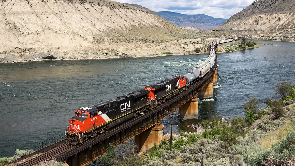 CN freight train crossing a river bridge near Ashcroft, British Columbia CN freight train crossing a river bridge near Ashcroft, British Columbia