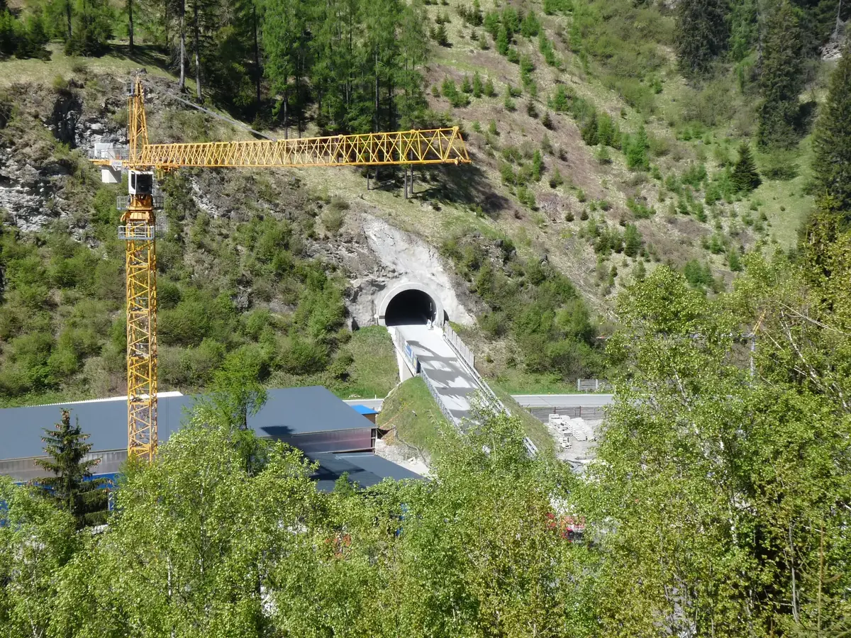 A crane stands beside an access tunnel at the Brenner Base Tunnel construction site in Austria. A crane stands beside an access tunnel at the Brenner Base Tunnel construction site in Austria.