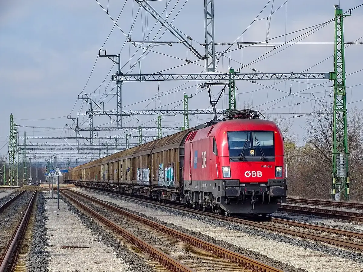 Red ÖBB locomotive hauling a Rail Cargo Hungaria freight train in Hungary. Red ÖBB locomotive hauling a Rail Cargo Hungaria freight train in Hungary.