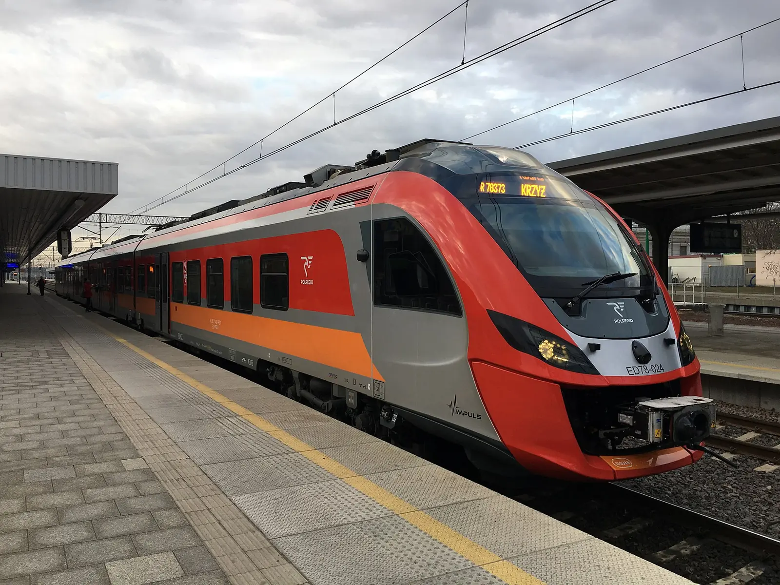 Red-and-grey PolRegio Newag Impuls ED78-024 electric train at Poznań Główny station
