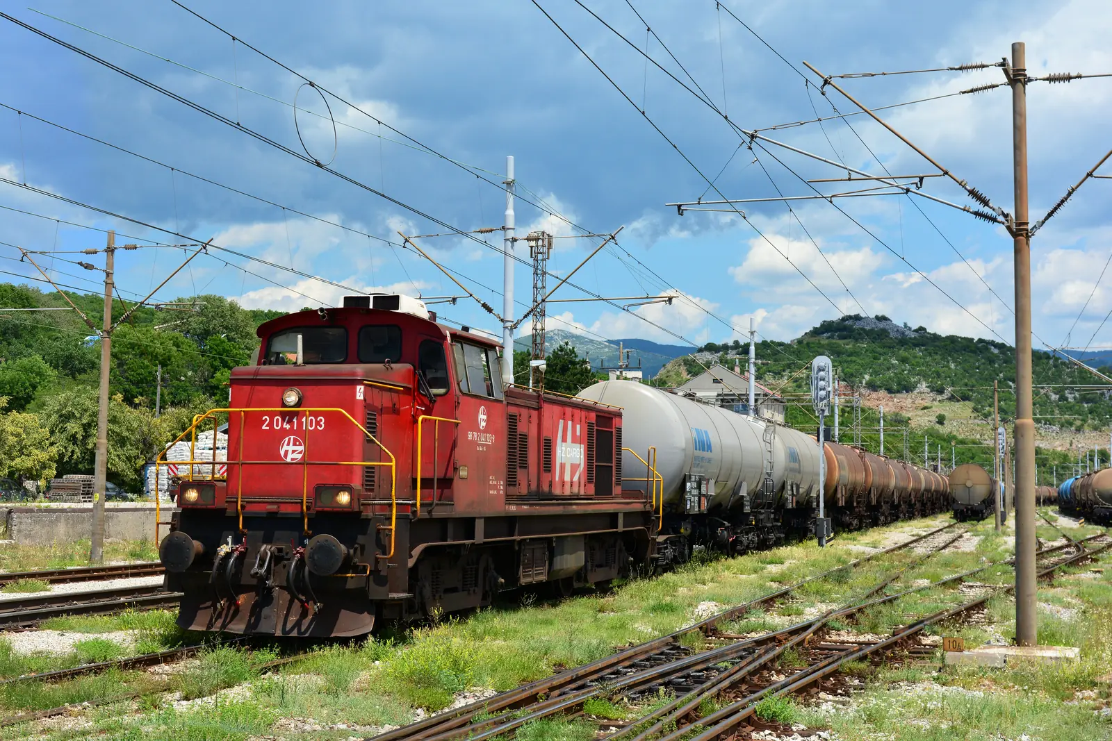 Red HŽ Cargo locomotive with a tanker train at Škrljevo station Red HŽ Cargo locomotive with a tanker train at Škrljevo station