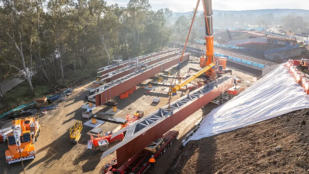 Aerial view of four steel girders and a crane at the Marchbanks Road bridge worksite in Broadford Aerial view of four steel girders and a crane at the Marchbanks Road bridge worksite in Broadford
