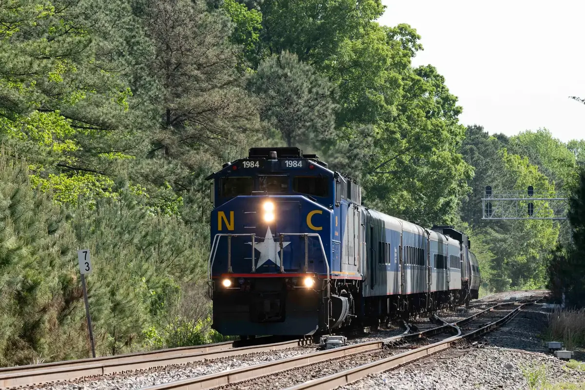 An NCDOT F59PH locomotive leads a Piedmont passenger train in Cary, North Carolina. An NCDOT F59PH locomotive leads a Piedmont passenger train in Cary, North Carolina.