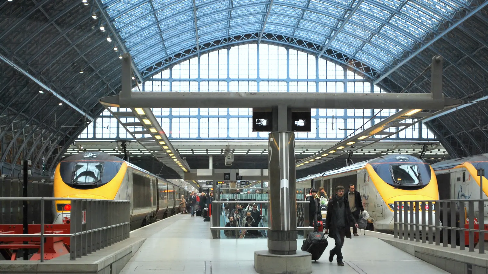 Two Eurostar trains at platforms inside London St Pancras station. Two Eurostar trains at platforms inside London St Pancras station.