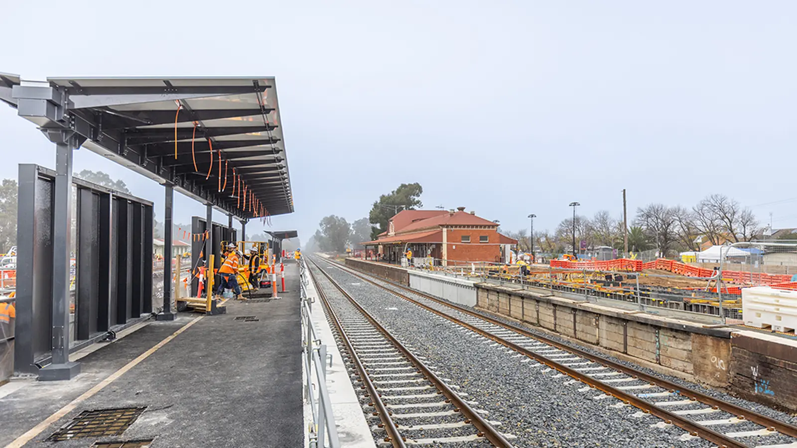 New platform canopy, railway tracks and construction crews at Benalla Station. New platform canopy, railway tracks and construction crews at Benalla Station.