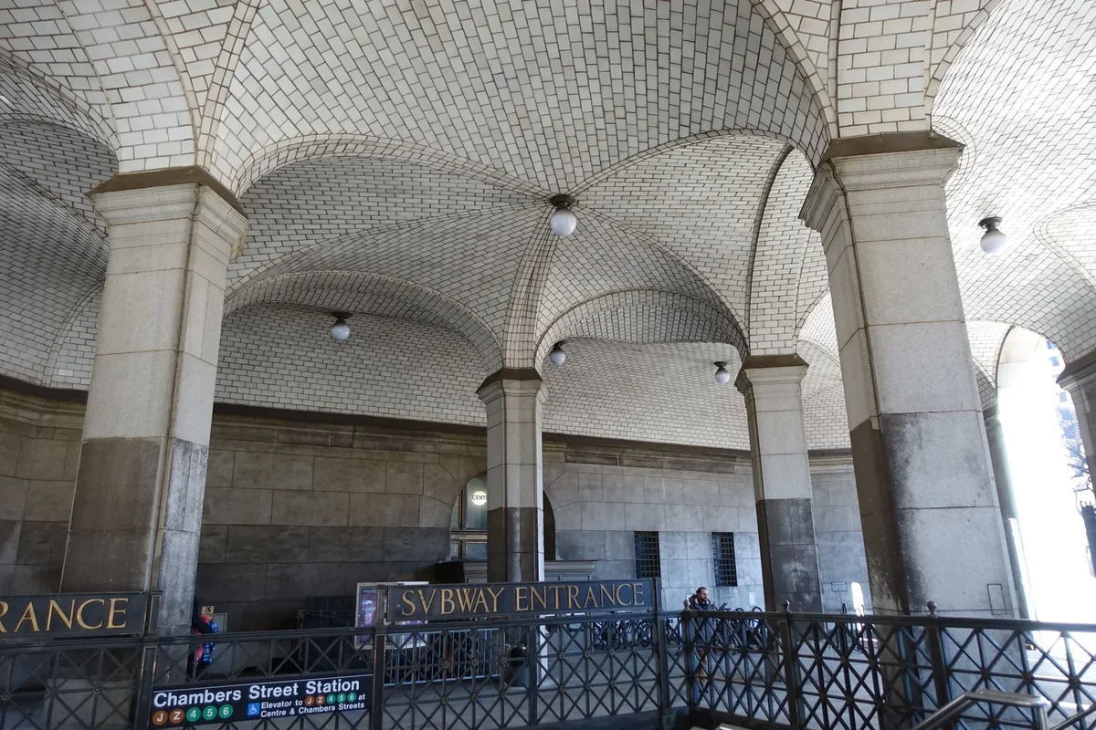 Tiled vaulted arcade and Chambers Street station entrance beneath the Manhattan Municipal Building. Tiled vaulted arcade and Chambers Street station entrance beneath the Manhattan Municipal Building.