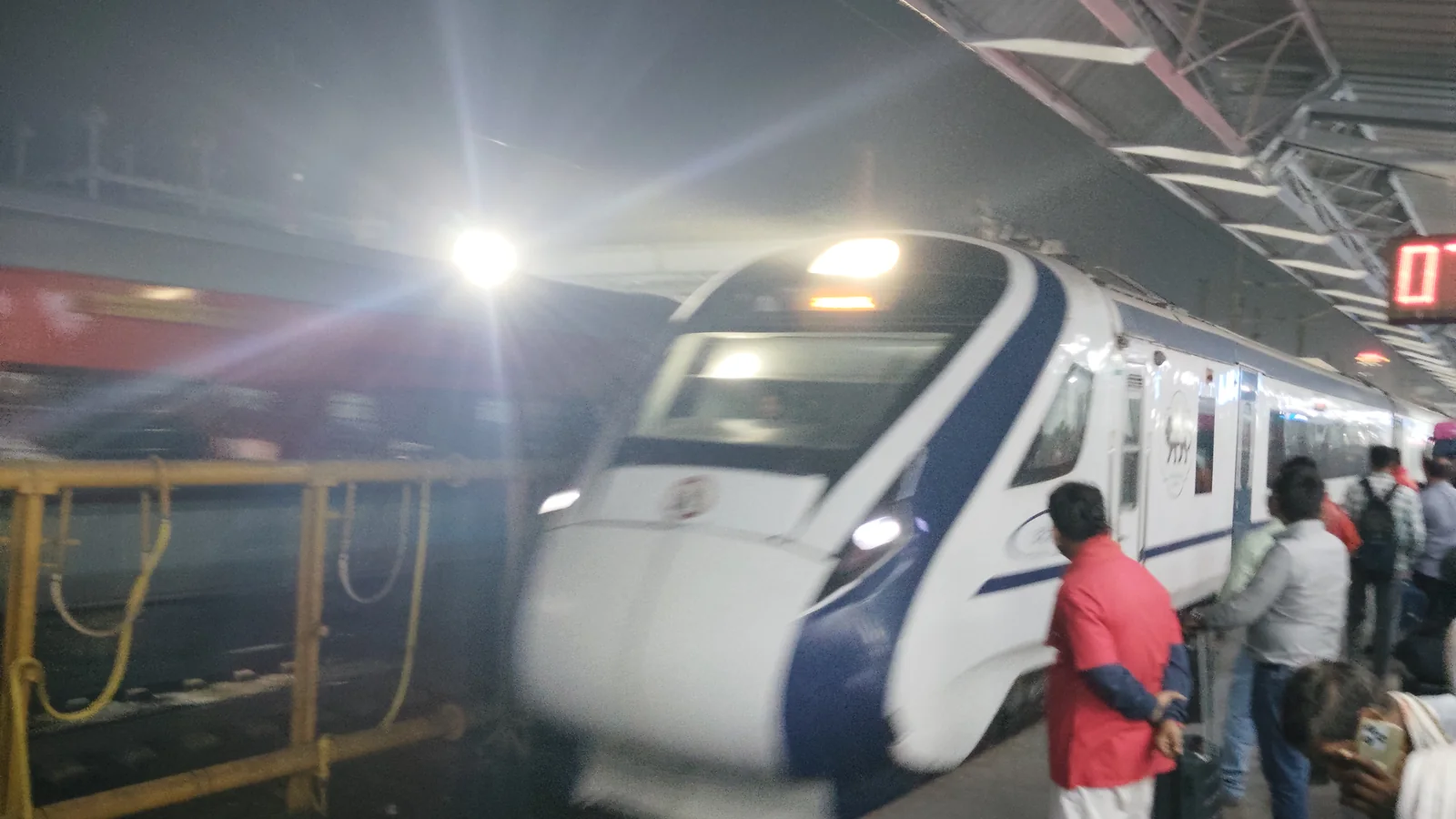 White-and-blue Vande Bharat Express train at a station platform White-and-blue Vande Bharat Express train at a station platform