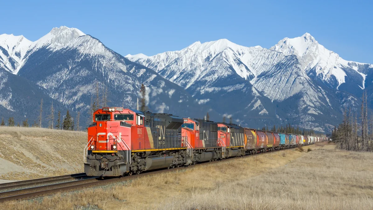 Canadian National freight train between Hinton and Jasper in Alberta with mountain peaks in the background Canadian National freight train between Hinton and Jasper in Alberta with mountain peaks in the background