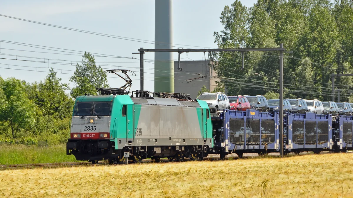 Belgian electric locomotive hauling car transport wagons toward the Port of Zeebrugge. Belgian electric locomotive hauling car transport wagons toward the Port of Zeebrugge.
