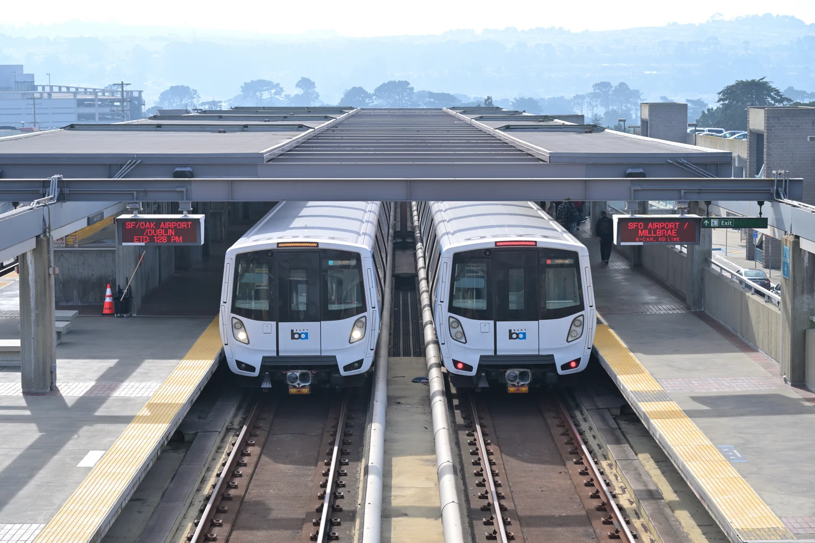Dublin-bound Blue Line and Millbrae-bound Red Line BART trains at Daly City station.