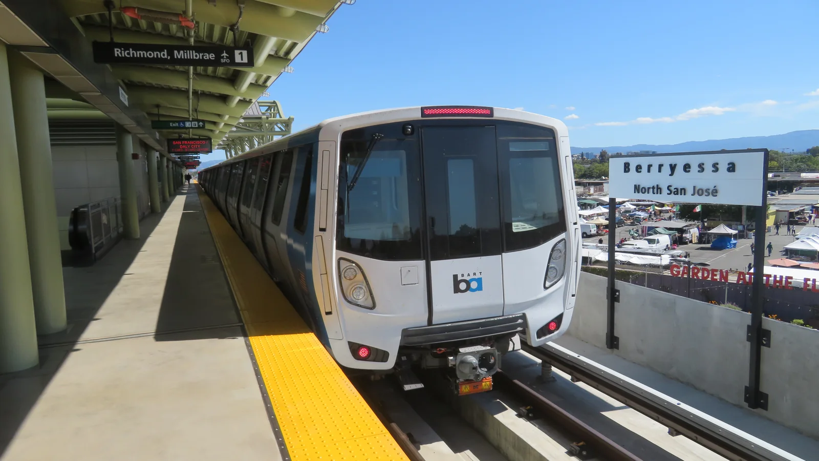 BART train at Berryessa/North San José station with the station sign visible beside the platform.