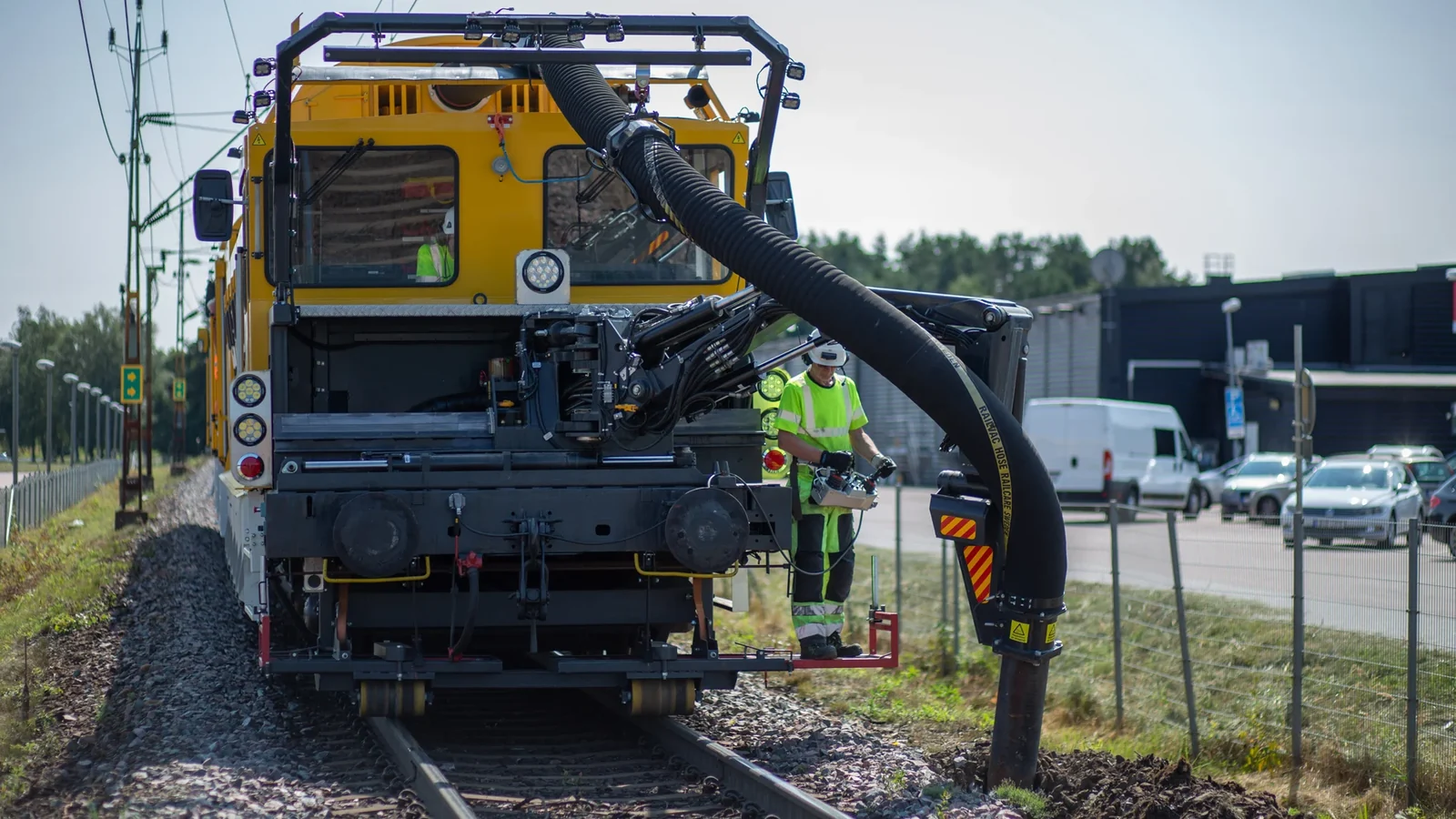 Railcare MPV vacuum maintenance machine with its suction hose beside railway track in Sweden