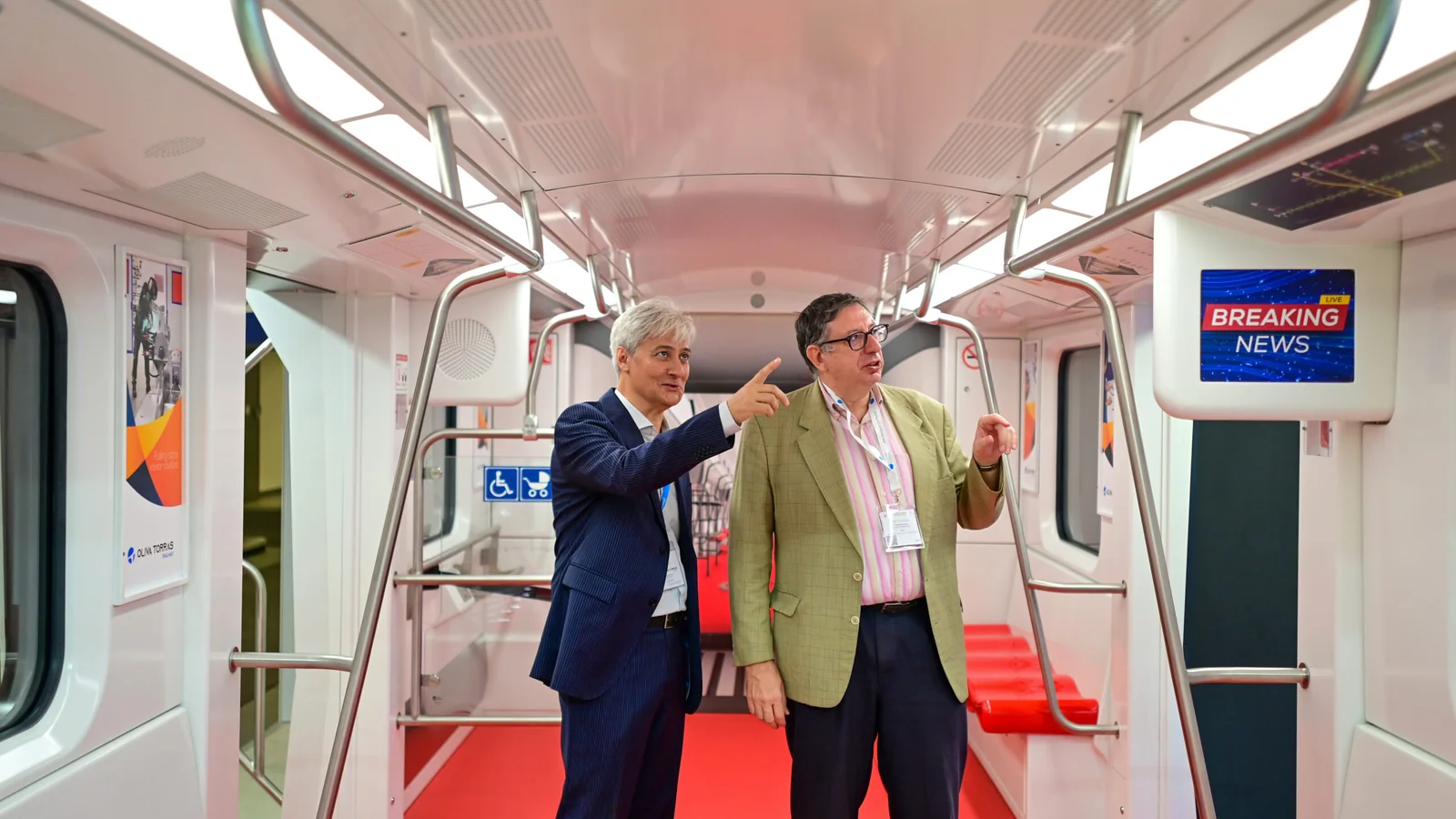 Rail vehicle interior displayed at InnoTrans 2024 with two visitors inside the carriage.