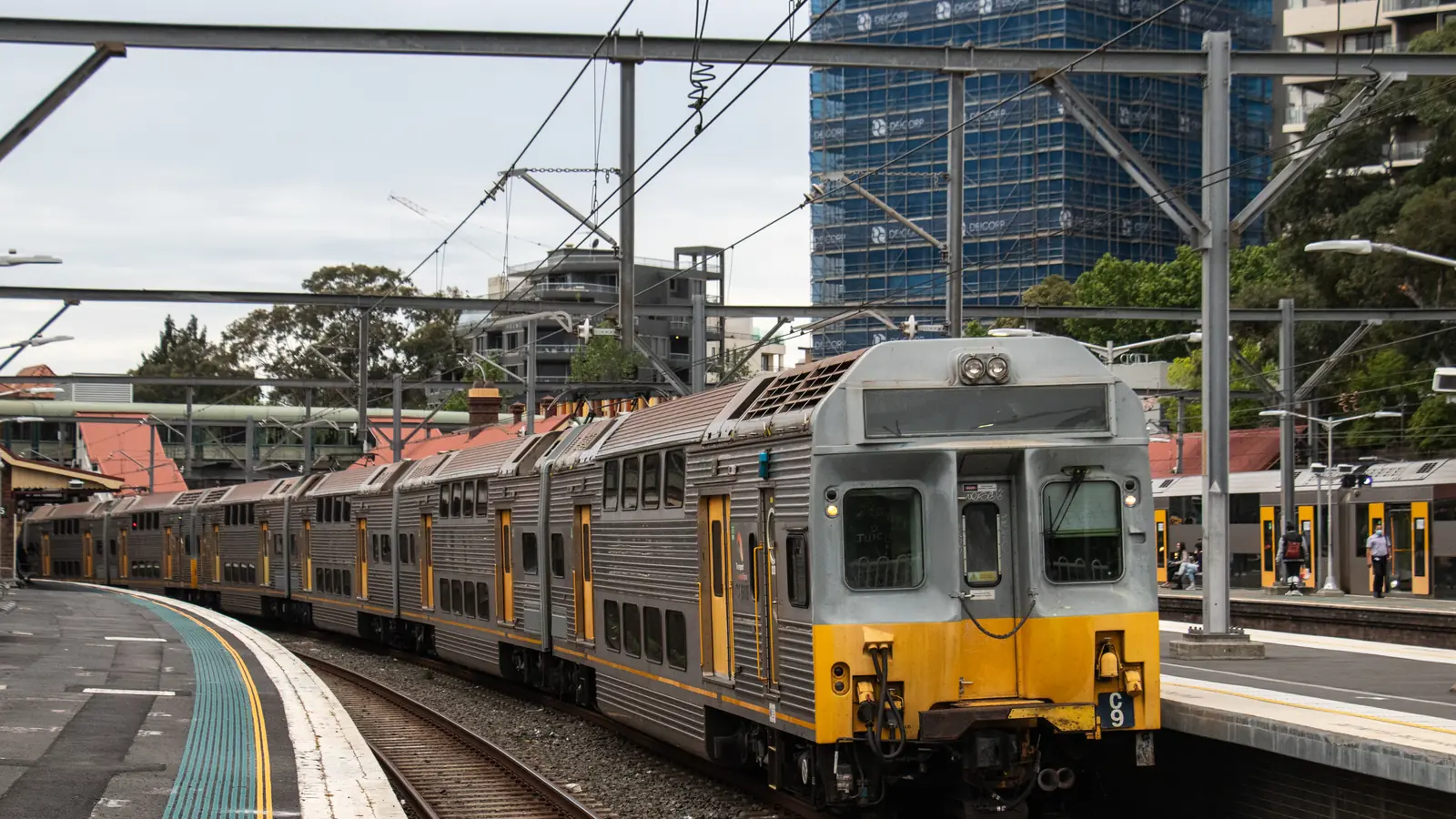 Sydney Trains service at Redfern station with overhead wiring above the platforms
