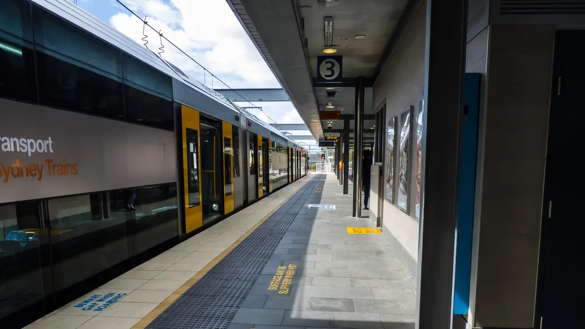 Sydney Trains service at Chatswood station beneath overhead wiring