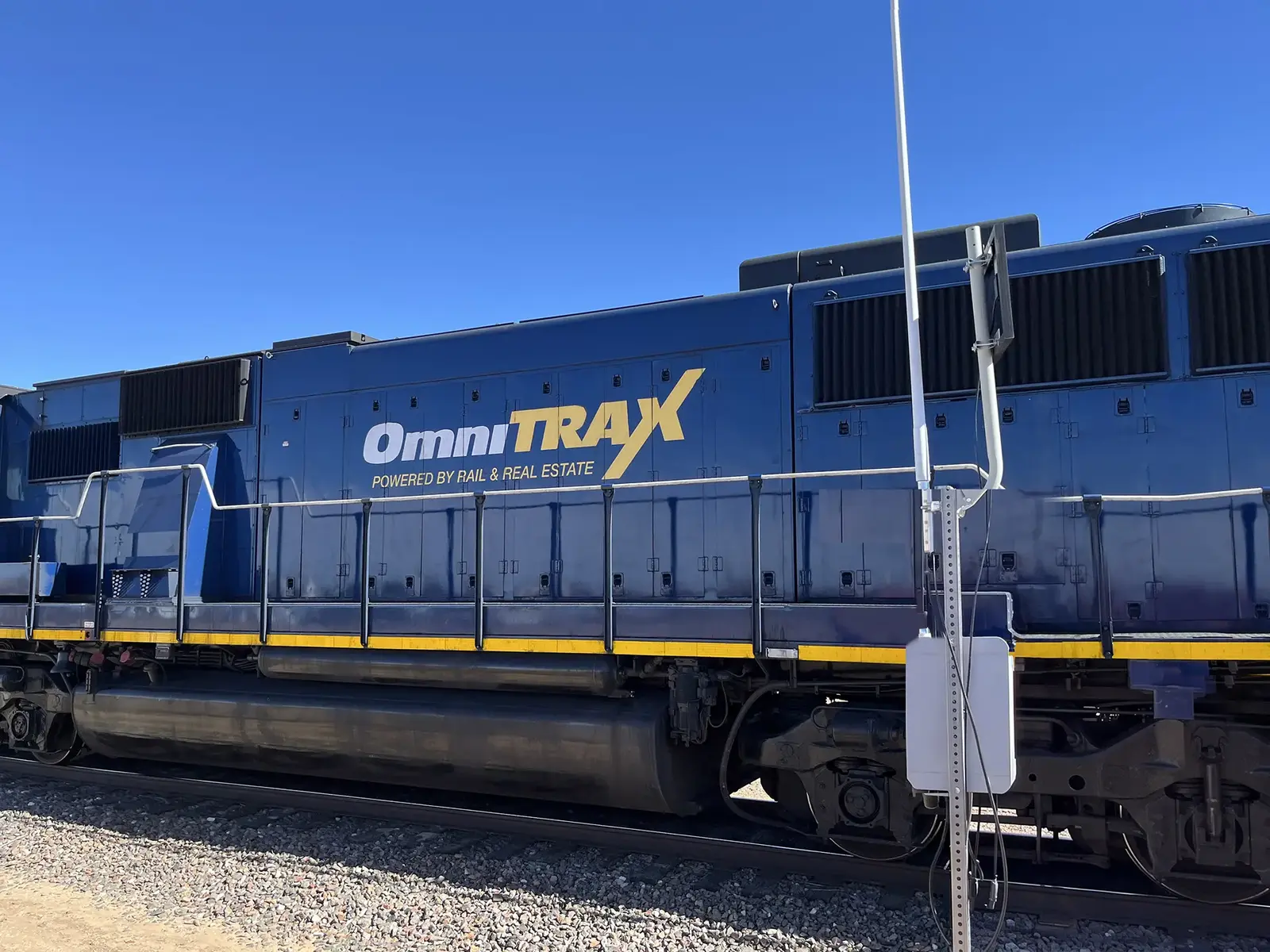 OmniTRAX locomotive beside an Athena ARCD monitoring unit on the Panhandle Northern Railroad