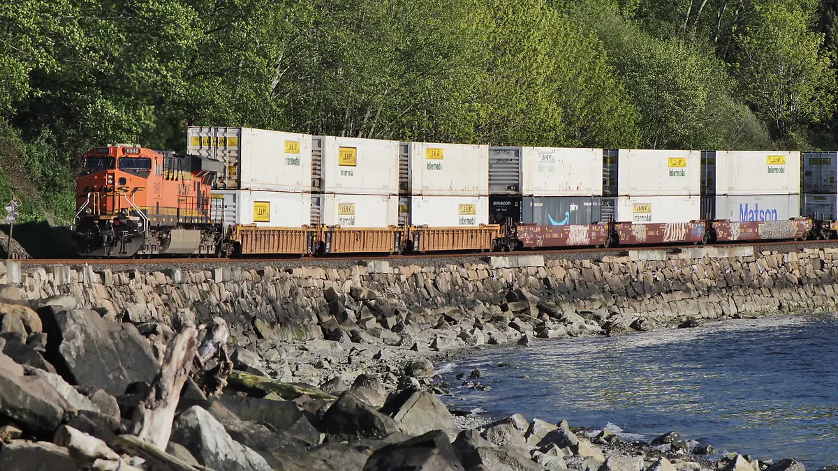 BNSF double-stack container train beside the shoreline at Richmond Beach, Washington