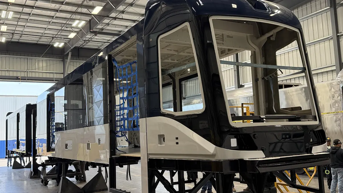 Painted shell of GCRTA’s new common railcar inside a manufacturing facility