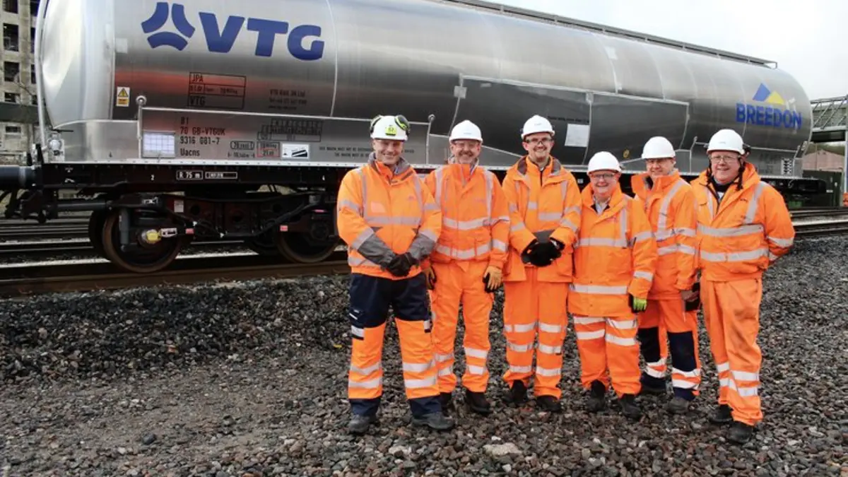 VTG and Breedon staff in orange PPE stand beside a silver JPA powder tank wagon