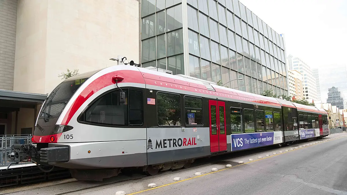 CapMetro GTW railcar 105 standing on street-level track in downtown Austin